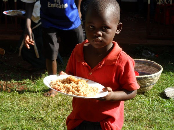 Child at The Global Village Childrens Project receiving much needed nutritious food.
